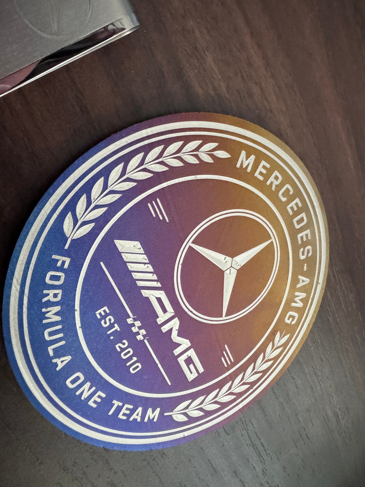 Set of four Mercedes-AMG Petronas F1 titanium coasters stacked